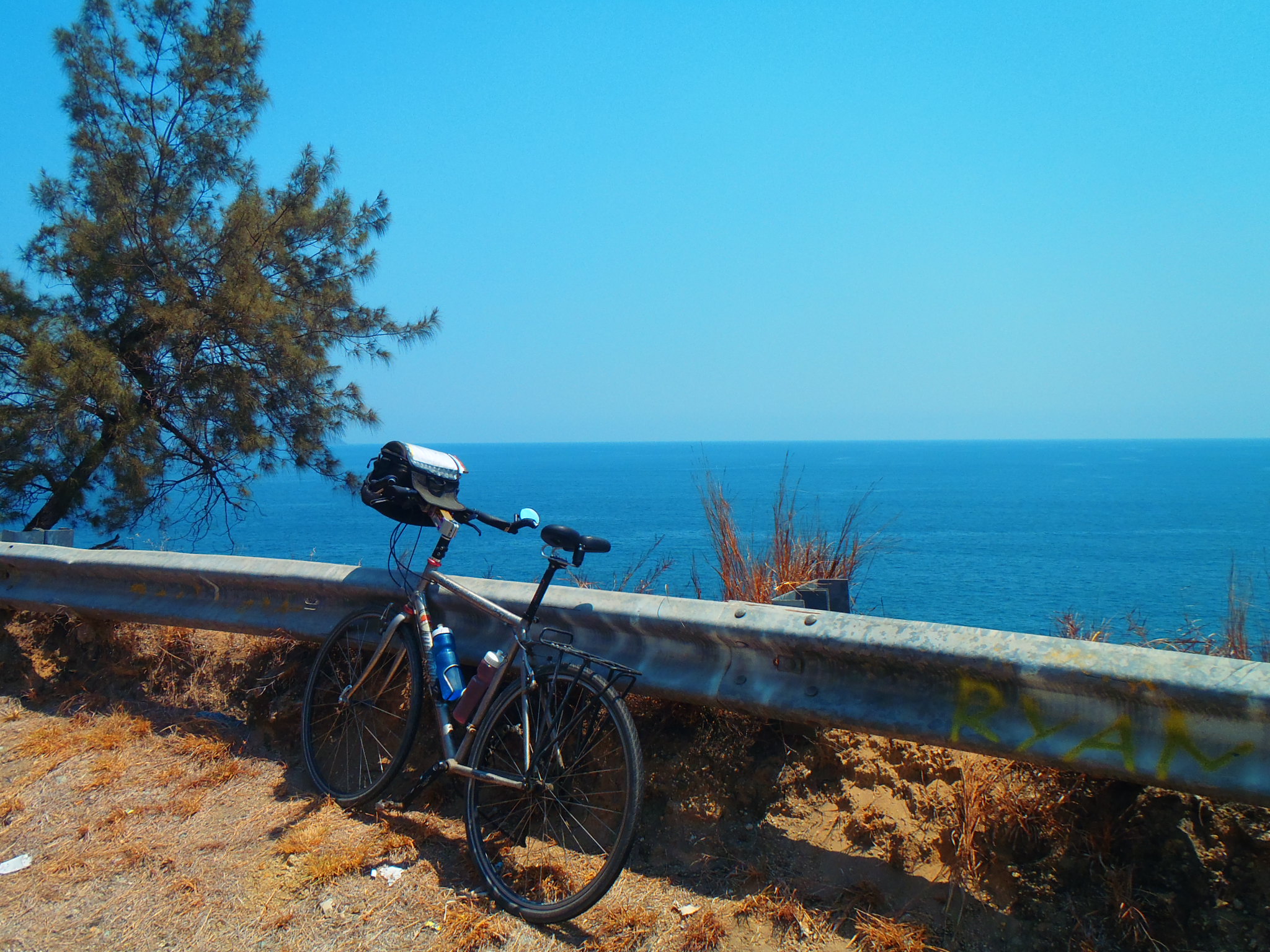 Henry-Tour D'Afrique-Bicycle along guard rail overlooking water